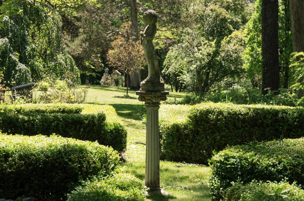 Lush green garden with a statue