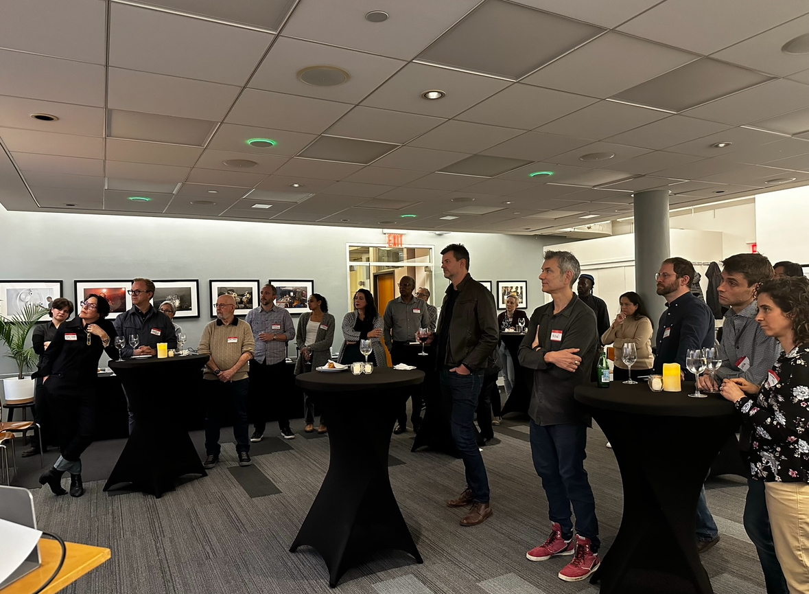 Faculty gathering to view a research presentation