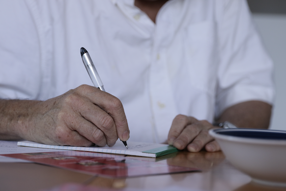 person writing with a pen