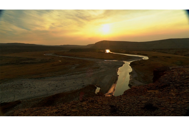 Sun, river, and mountain rocks