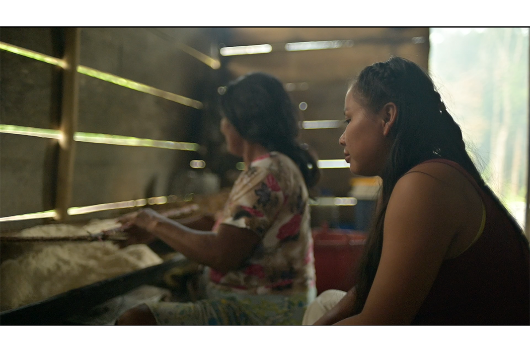 Two woman sitting and cooking