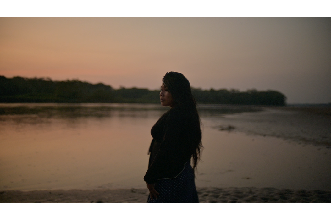 Woman standing in front of a lake