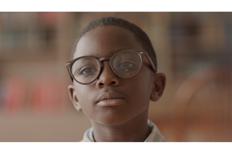 Little boy with glasses in the library