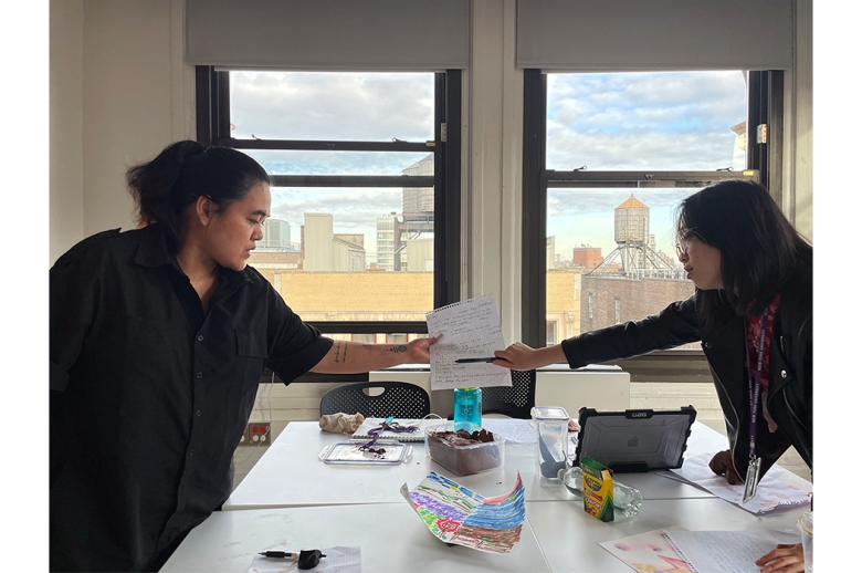 Two people looking over a piece of paper