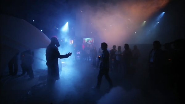 Performance Art in dark room with colored lights and smoke