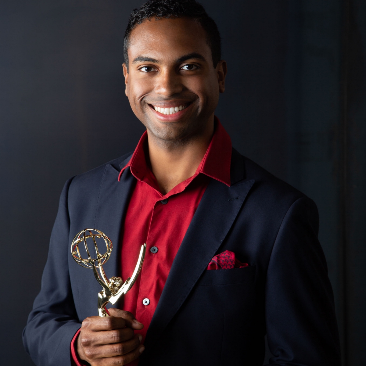 Antonio Ayala holds an EMMY