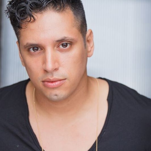 Ricardo Gamboa headshot. Black hair, black shirt