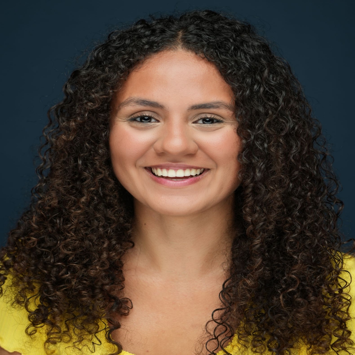 Enid Marie Headshot Yellow Shirt