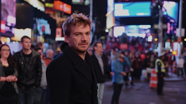 A still from Julia Solomonoff's third feature film, Nadie nos mira (Nobody's Watching). Nico (played by Guillermo Pfening) stands in the center of Times Square amidst a crowd of people.