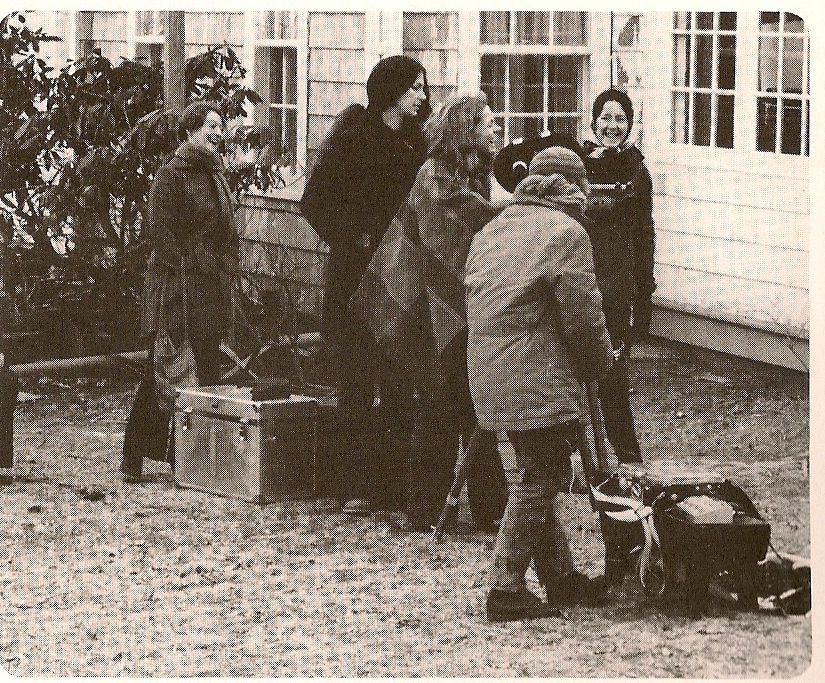 four women standing in front of a house