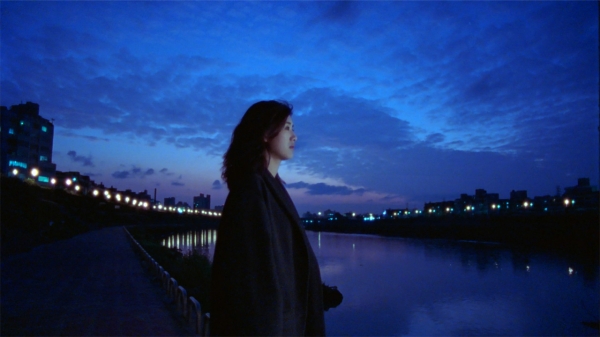 A still from Blue Moon: A woman looking solemn.