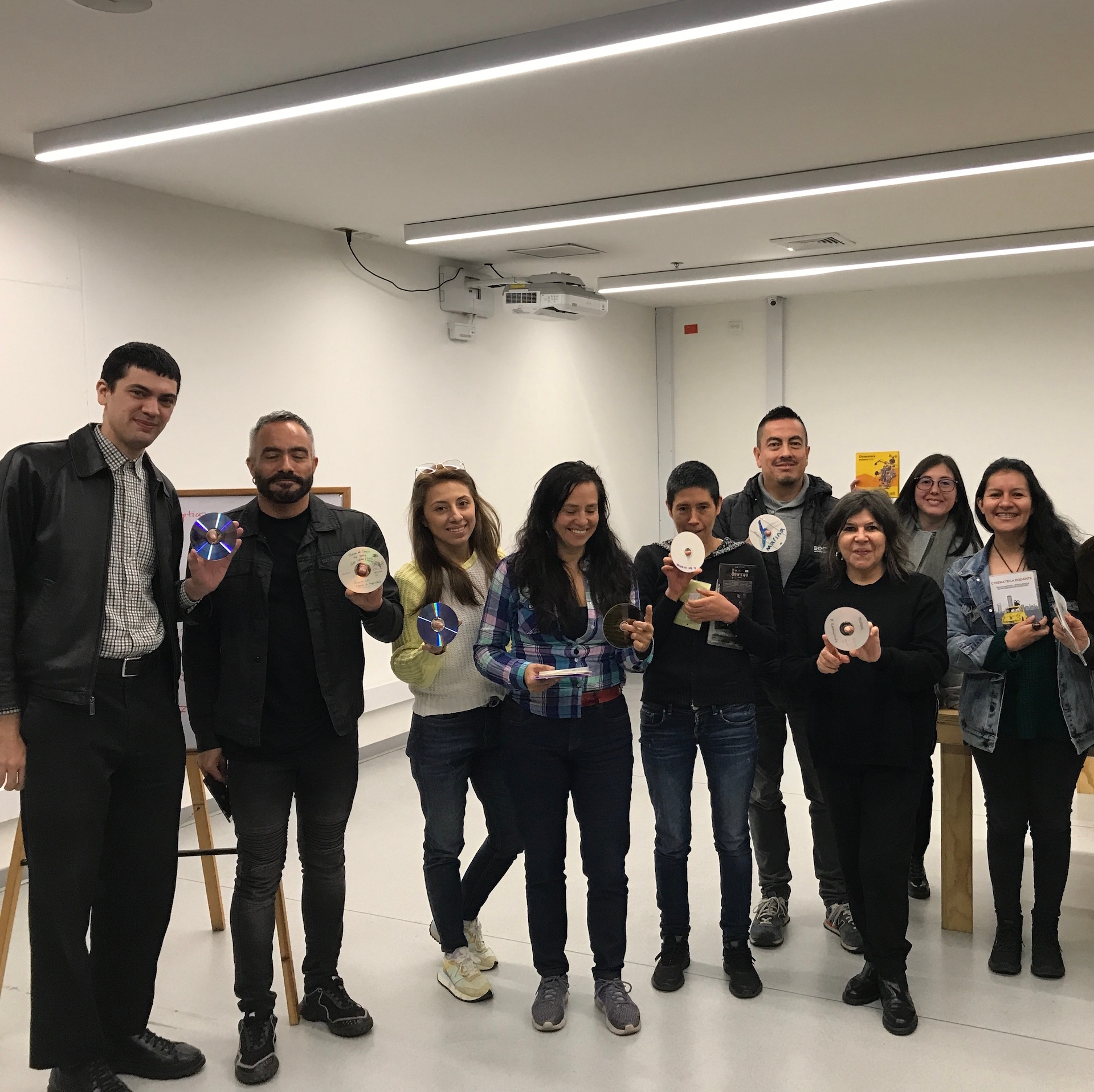 group shot of people holding up CDs