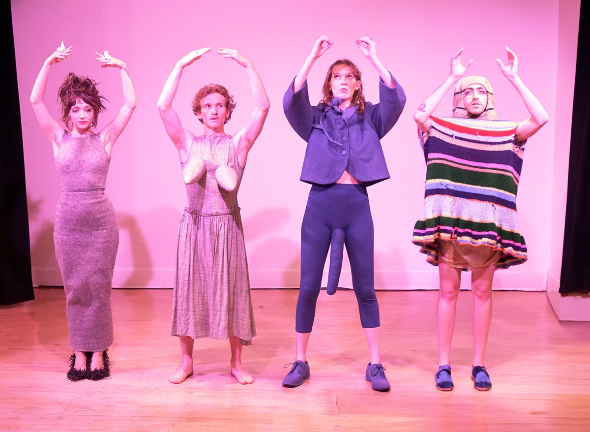 Beau and three other performers pose with hands over their heads, each wearing a unique costume