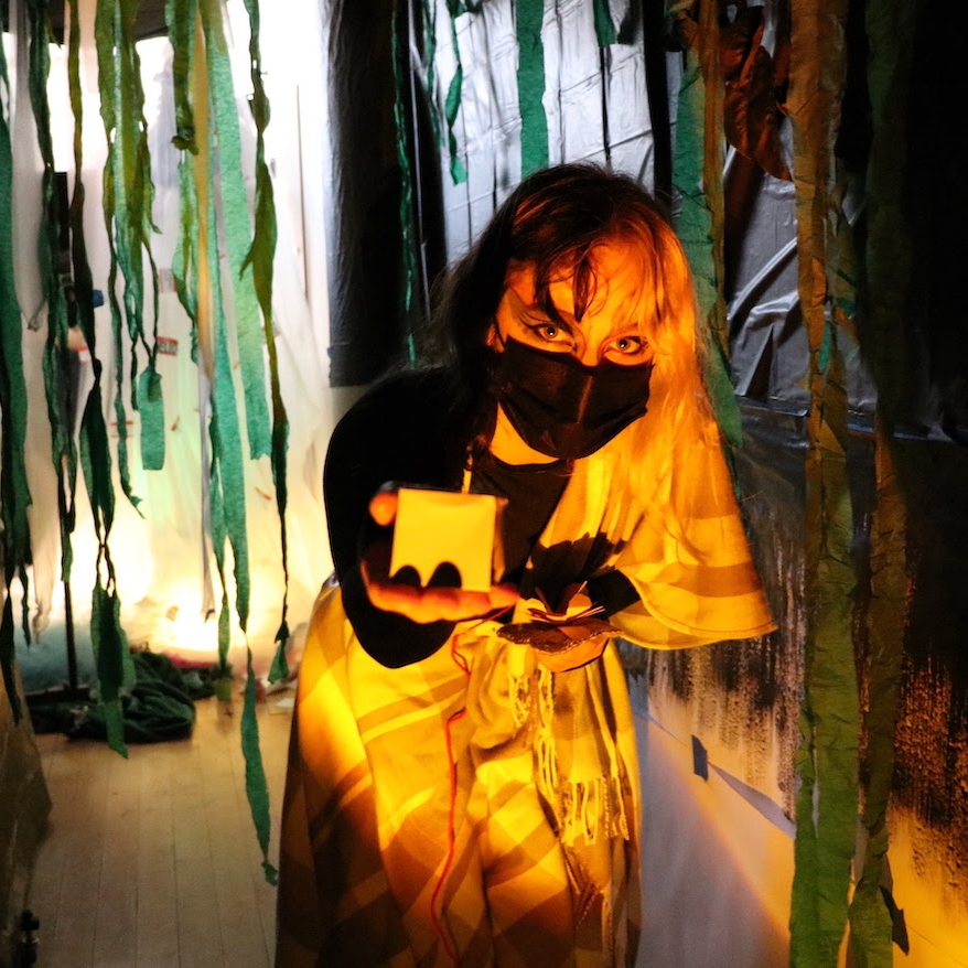 masked student surrounded by streamers