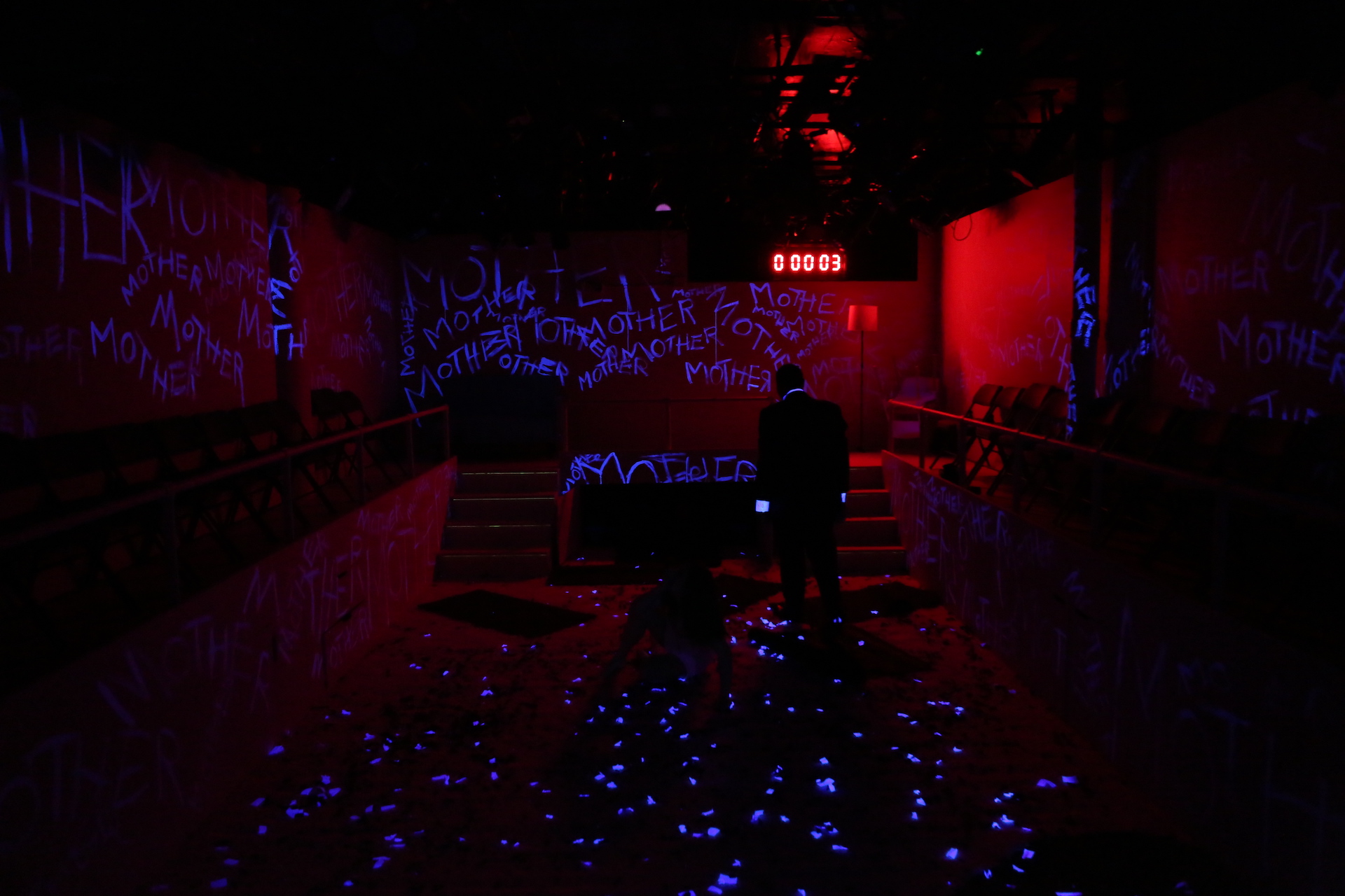 A dark room with glowing blue text on the walls