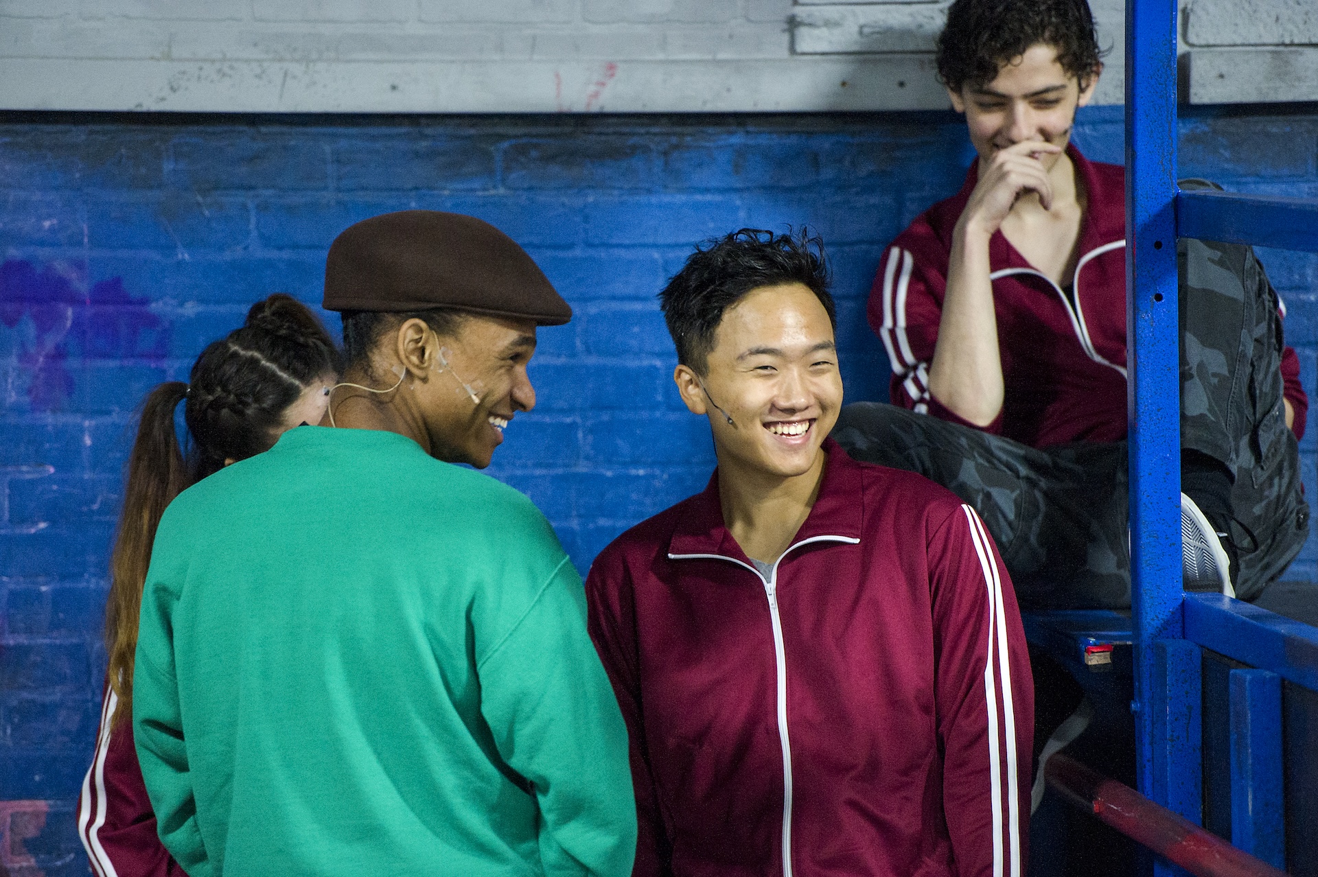 actors onstage laughing together