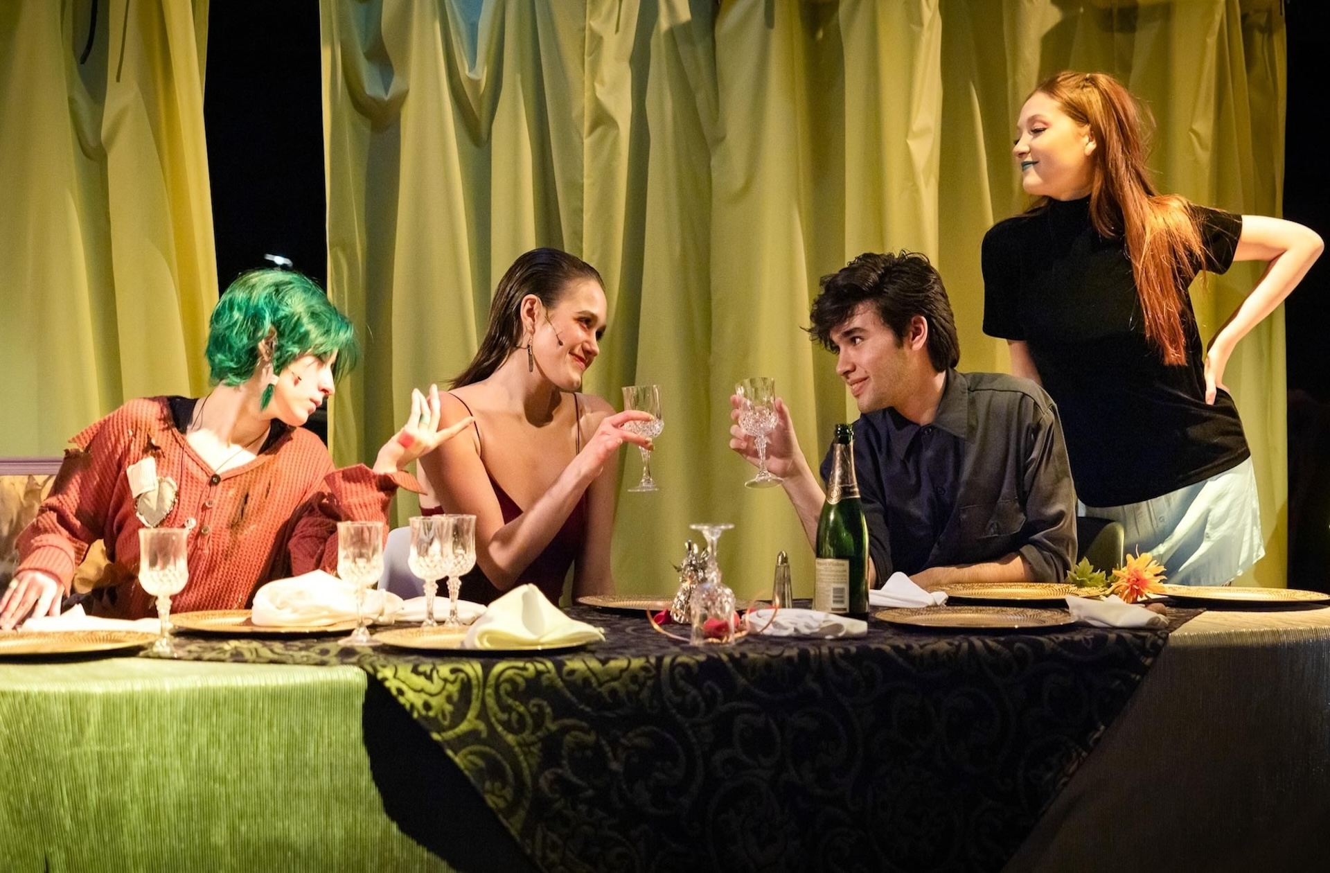 group of actors sitting at the table