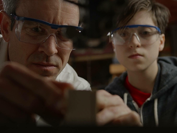 Film Still from The Derby. Image of dad and son building something together.