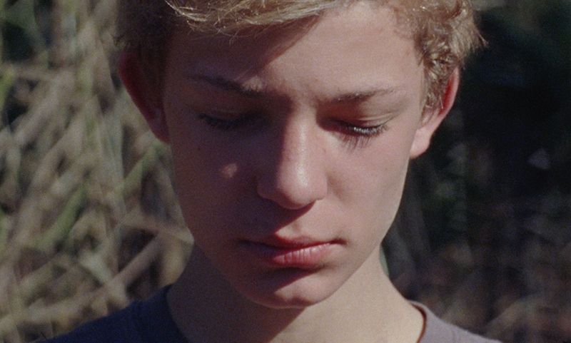 A close-up of a young woman with her eyes closed.