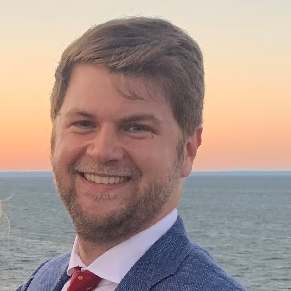 Image of Kenny Langer in blue suit & red tie