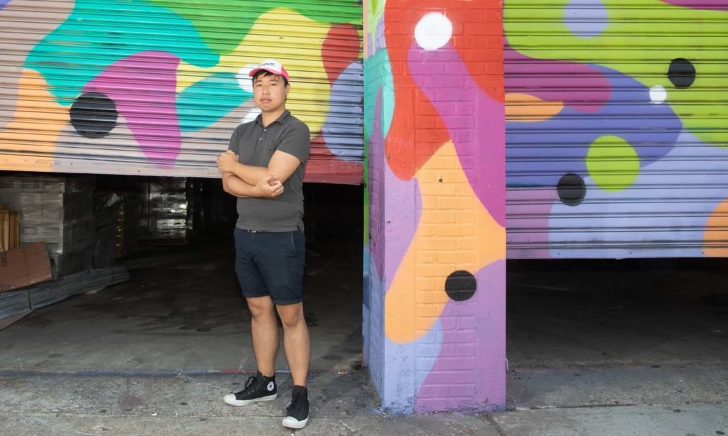 Robert Yang stands in front of painted doorway