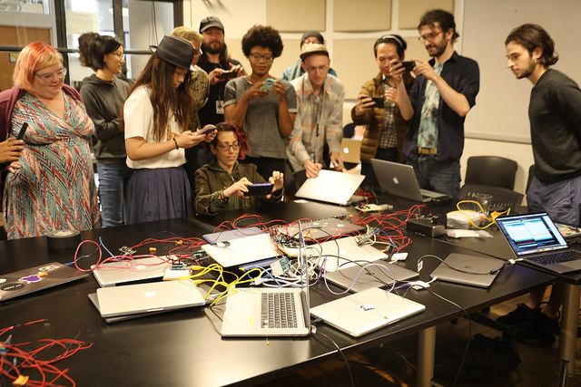 Campers use VR equipment grouped together in classroom