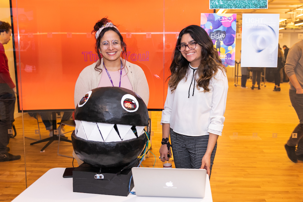 Students smile in front of project 