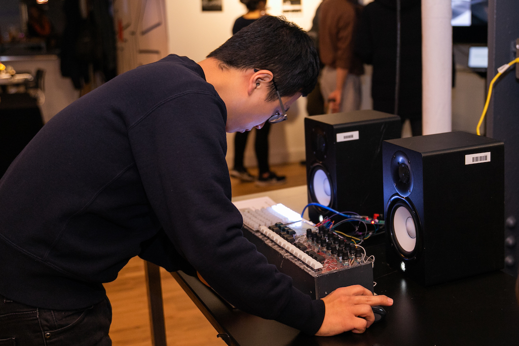 Student bends over sound system