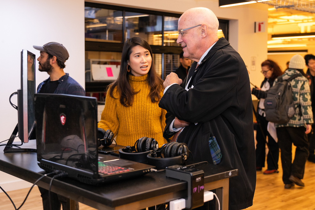 NYU President Andy Hamilton talk to a student