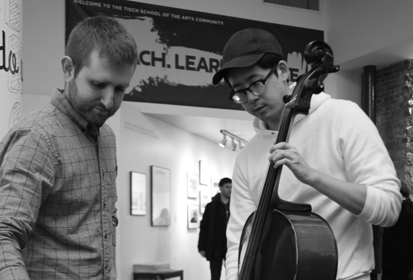 a man holding up a cello