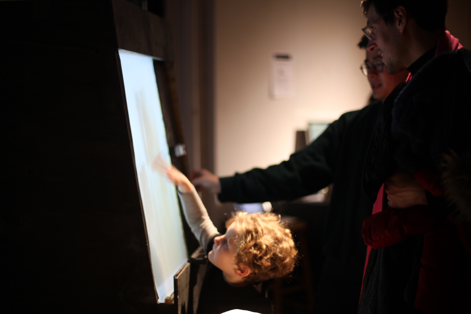 people interacting with a glowing screen