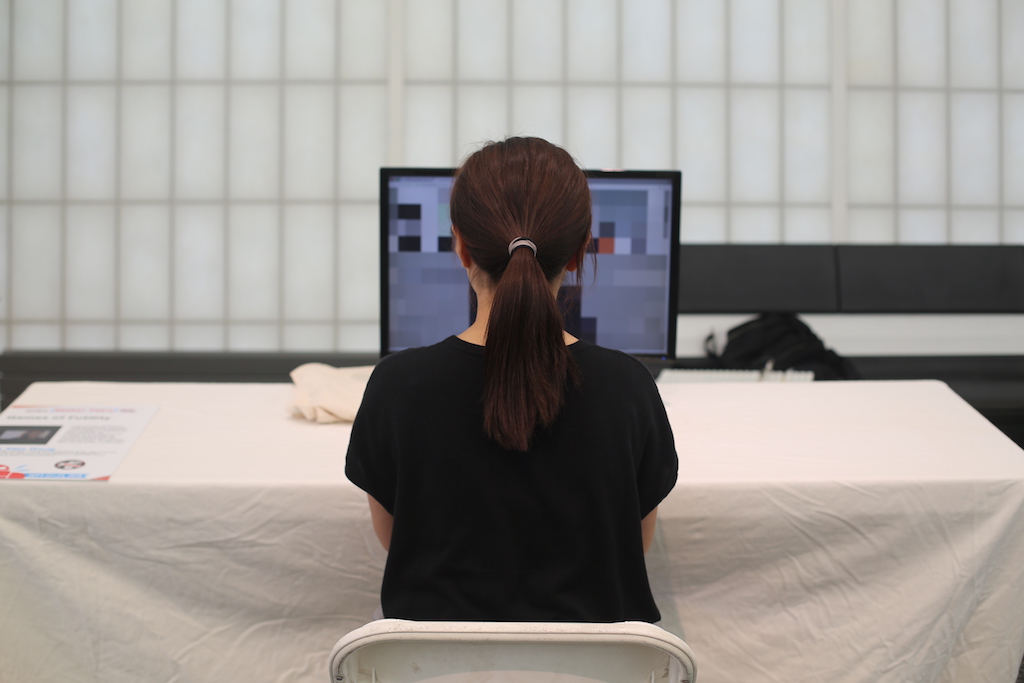 Student faces away from camera working on computer