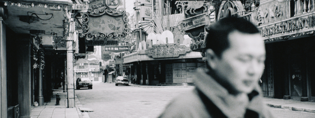 A man facing to the right on an empty shanghai street