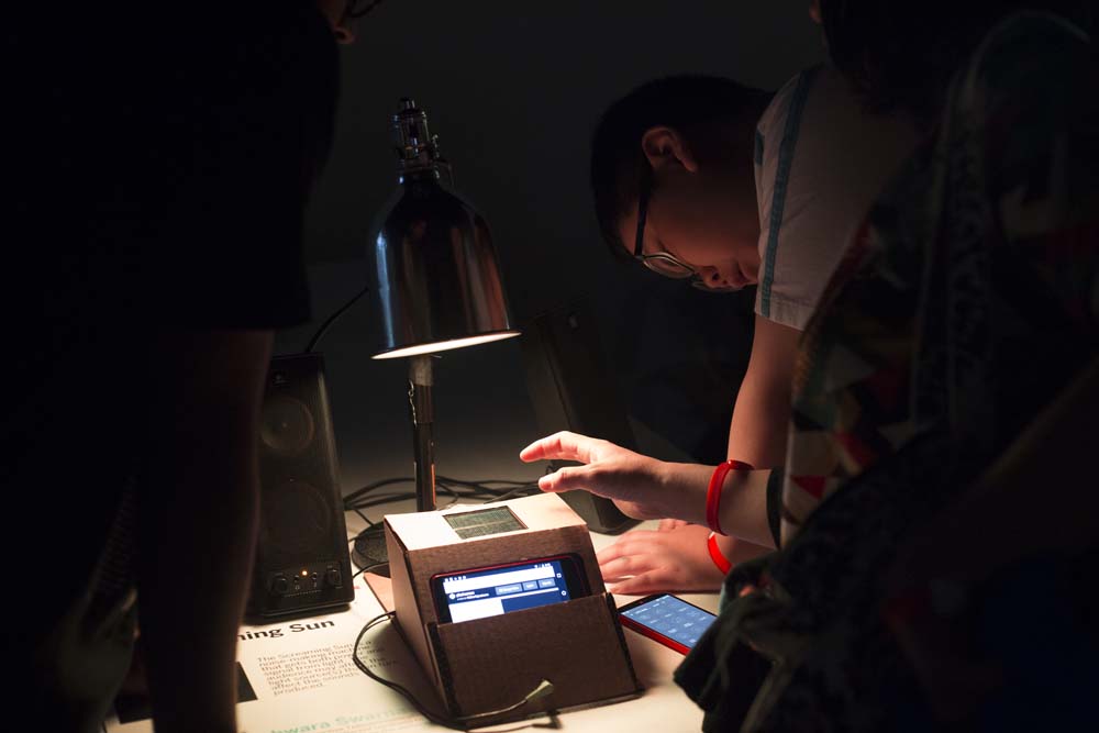 A person studies a cardboard box that holds an iphone