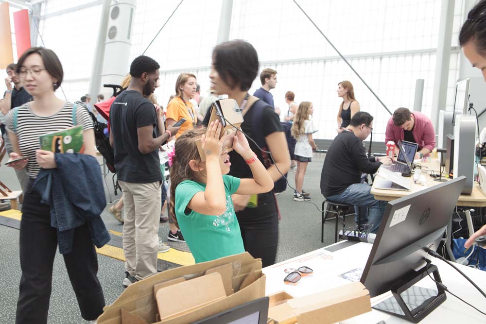 A young child watches something using Google Cardboard