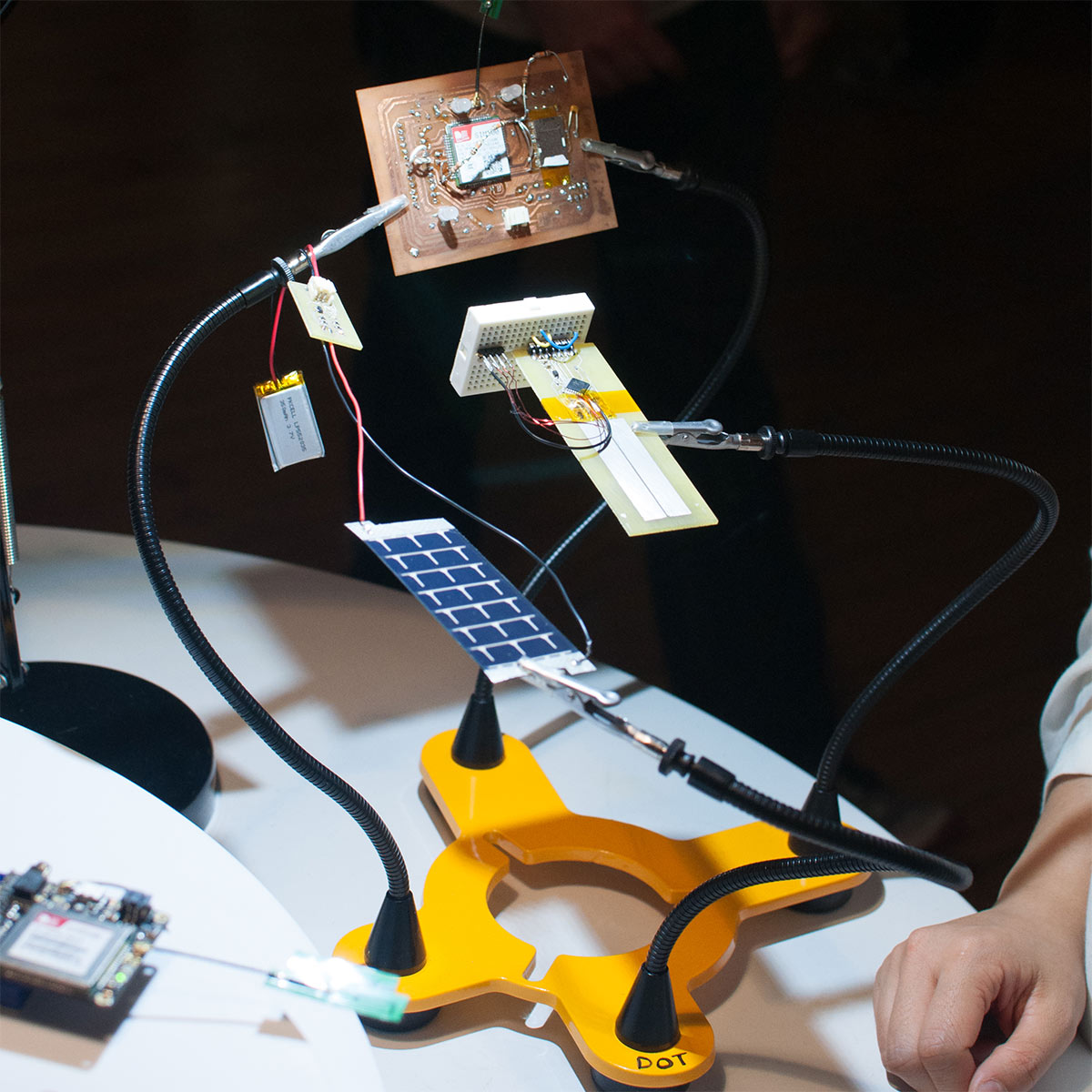 clamps that are holding a breadboard and a microprocessor