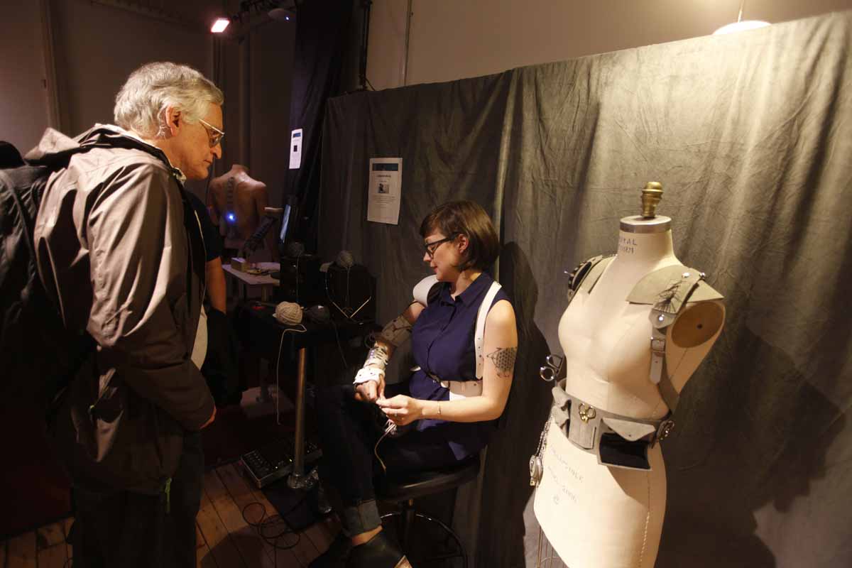 A woman showing wearables - an arm controller