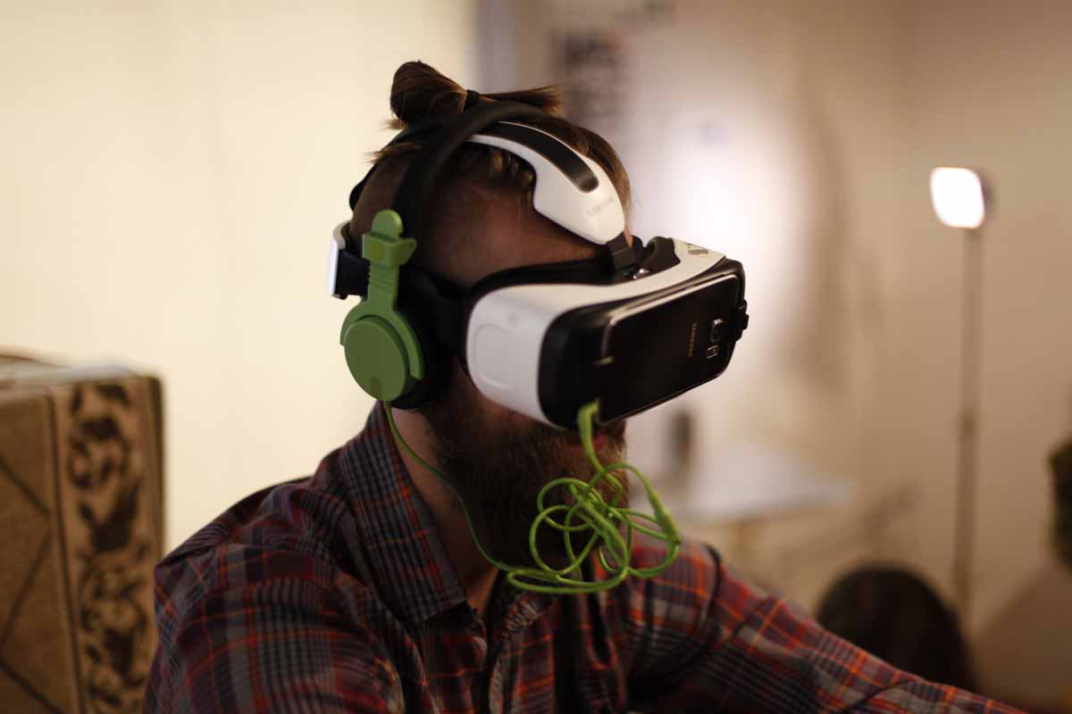 a man wearing VR goggles and headphones