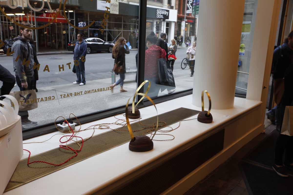 a window display showing vibrating sculptures