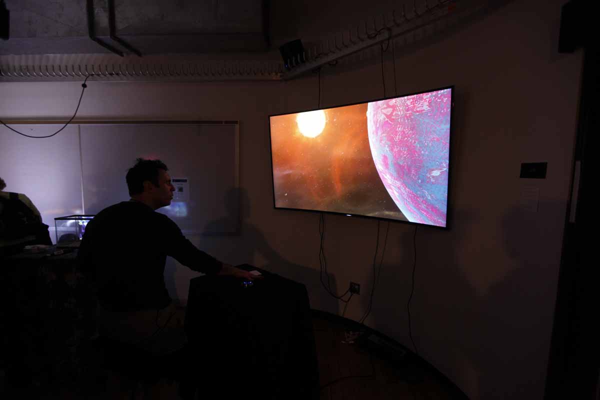 a monitor showing the sun going around a planet