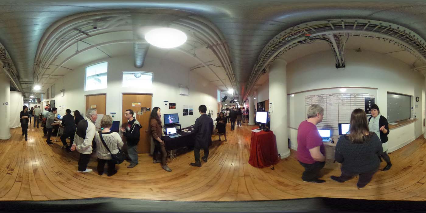 a 360 image of the hallway and people standing by projects at the show