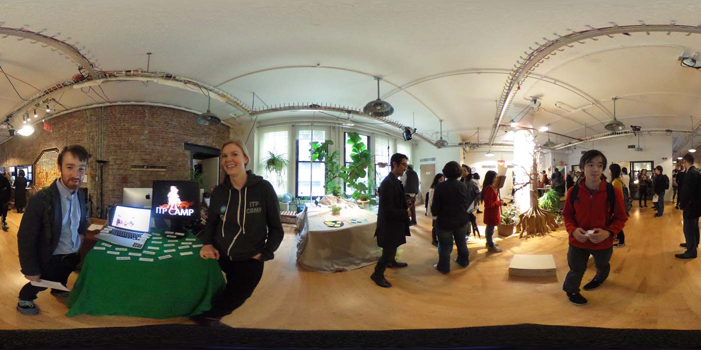 a 360 image of the hallway and people standing by projects at the show