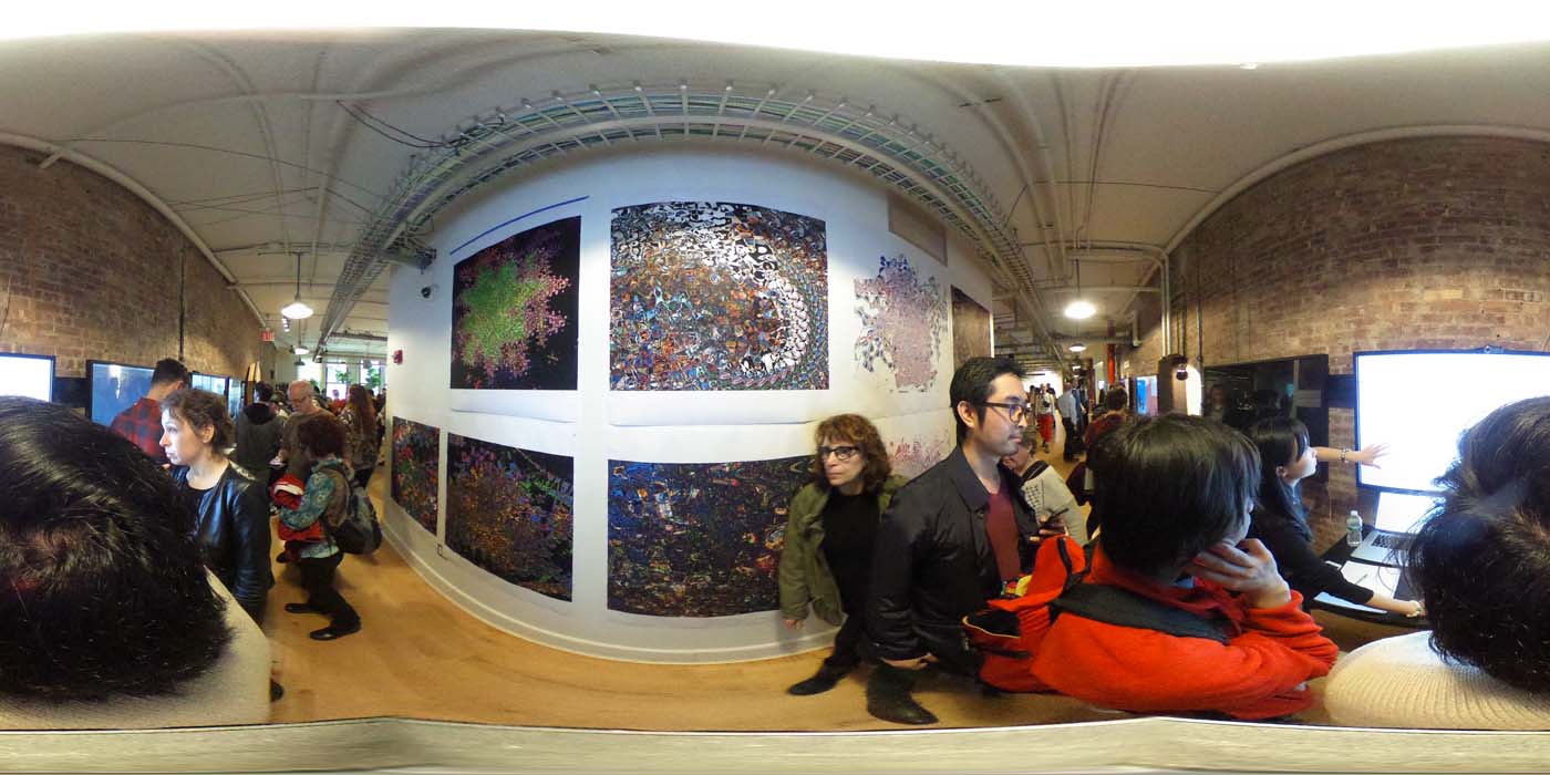 a 360 image of the hallway and people standing by projects at the show