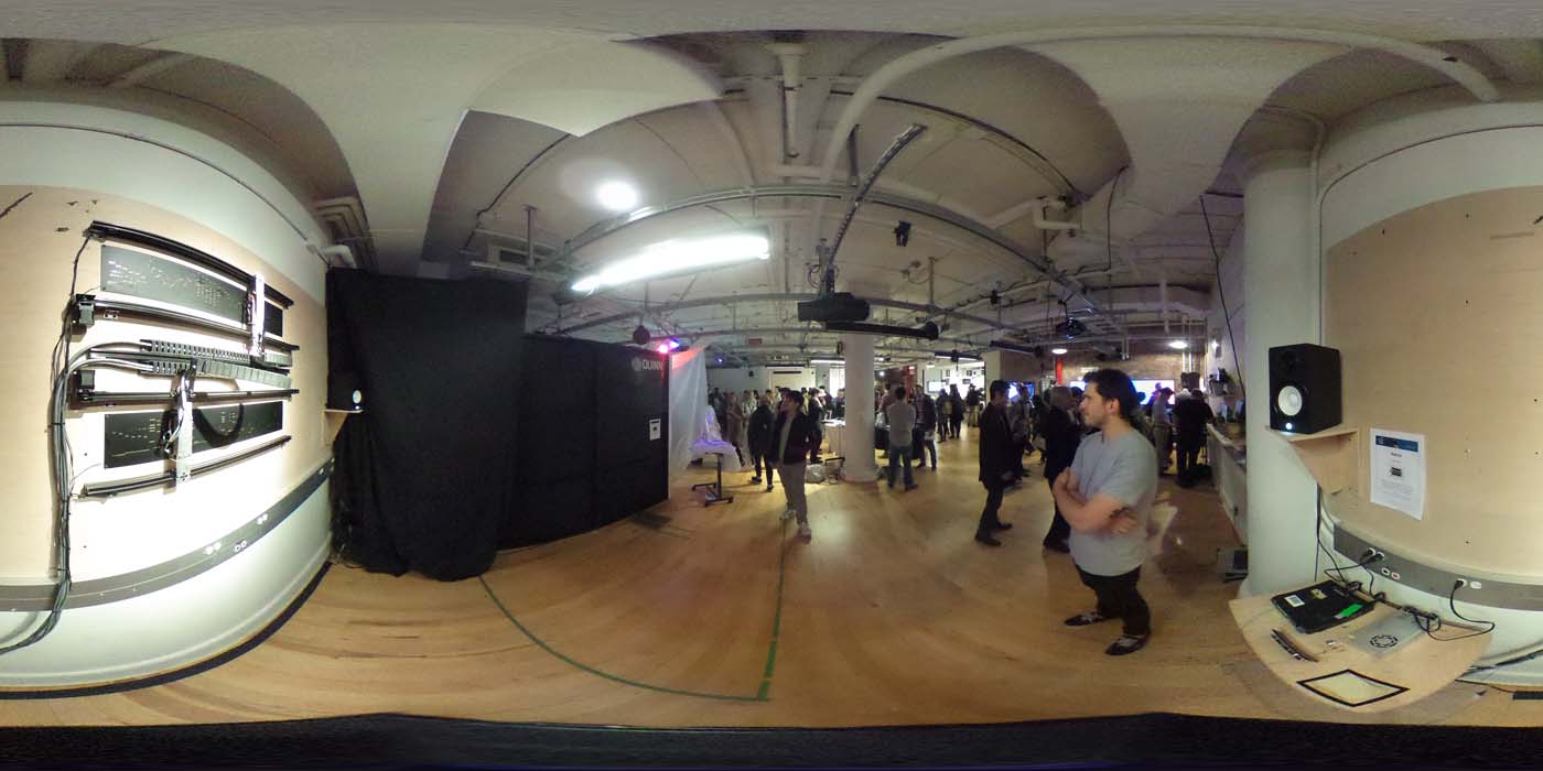 a 360 image of the hallway and people standing by projects at the show