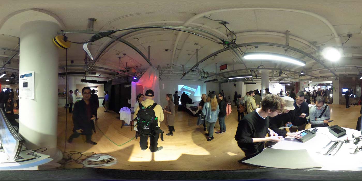 a 360 image of the hallway and people standing by projects at the show