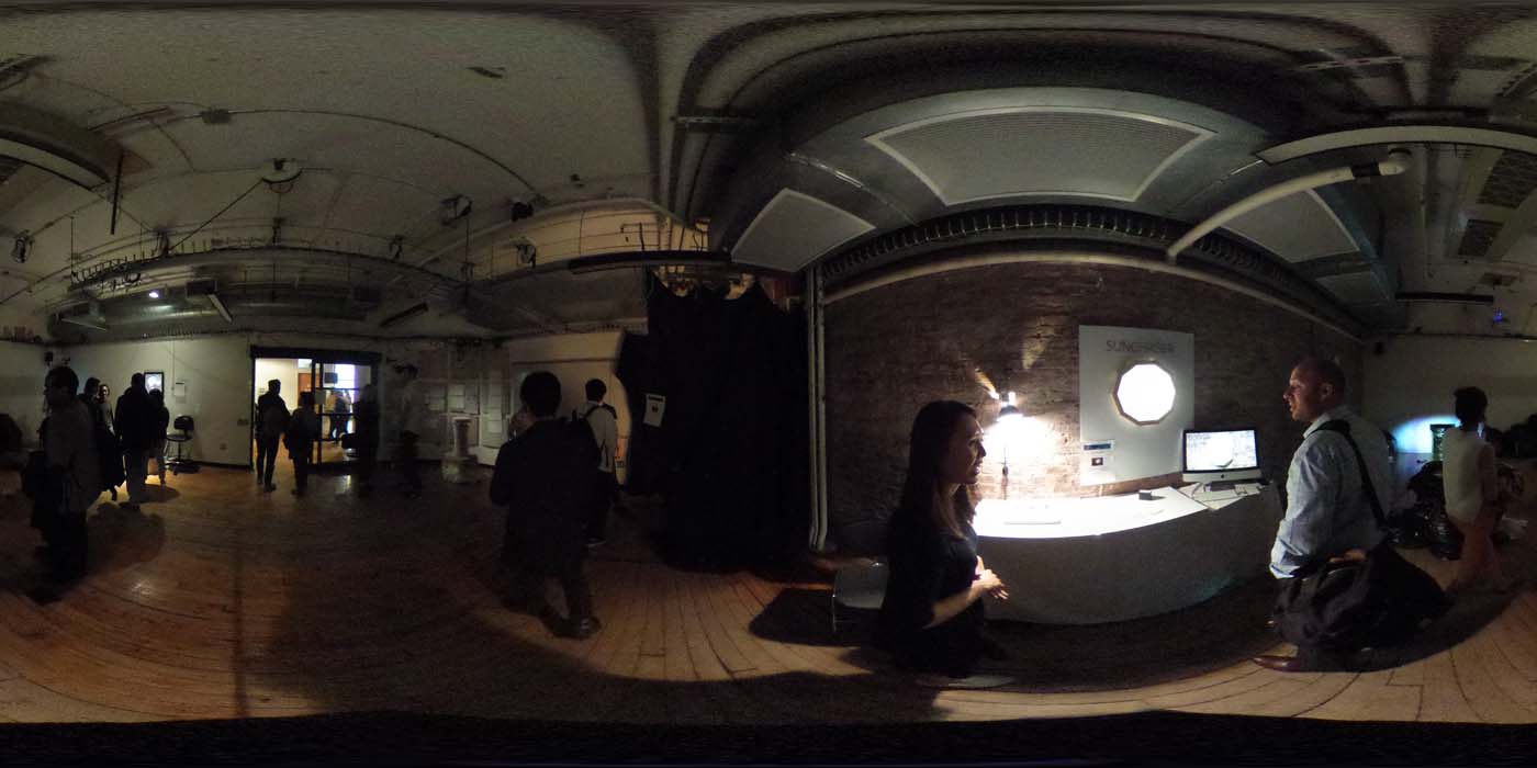 a 360 image of the hallway and people standing by projects at the show