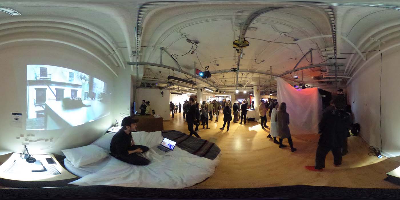 a 360 image of the hallway and people standing by projects at the show