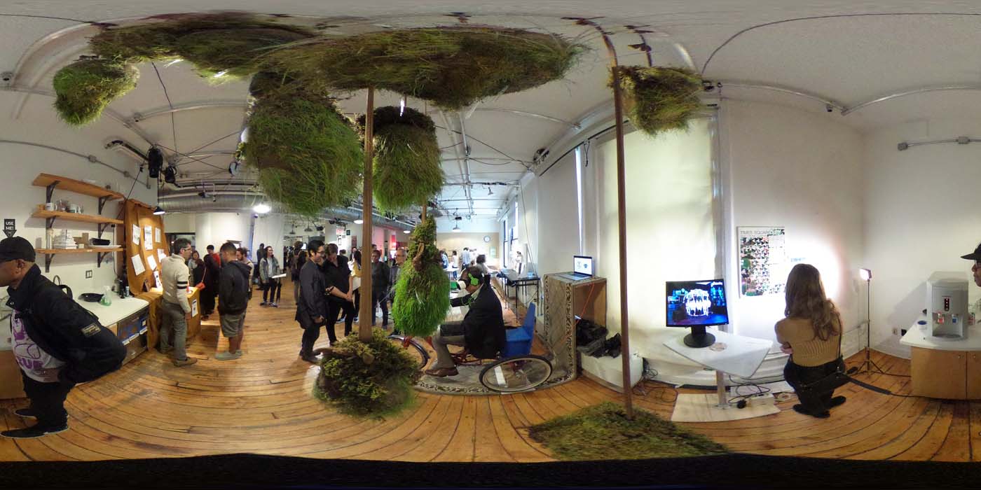 a 360 image of the hallway and people standing by projects at the show