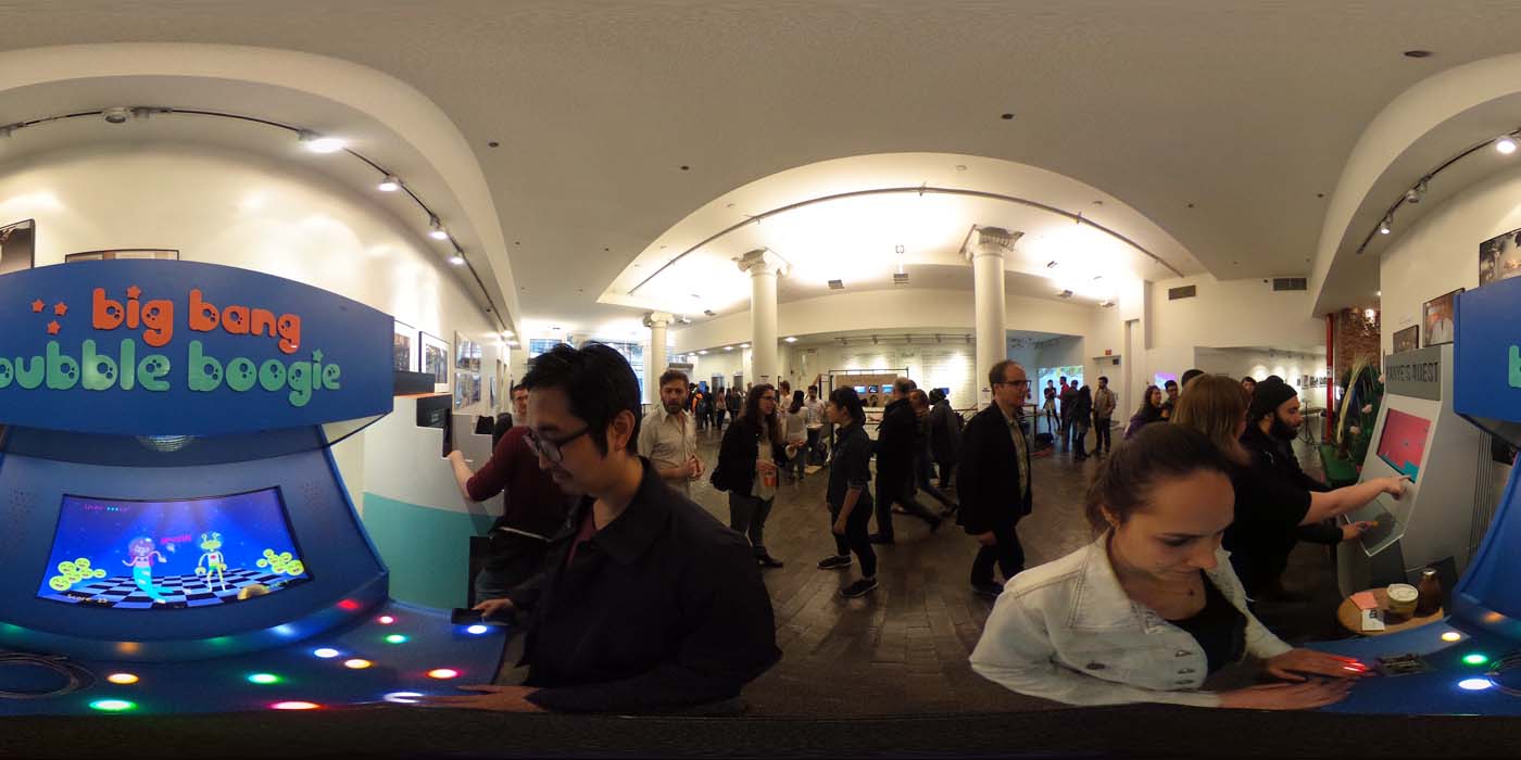 a 360 image of the hallway and people standing by projects at the show