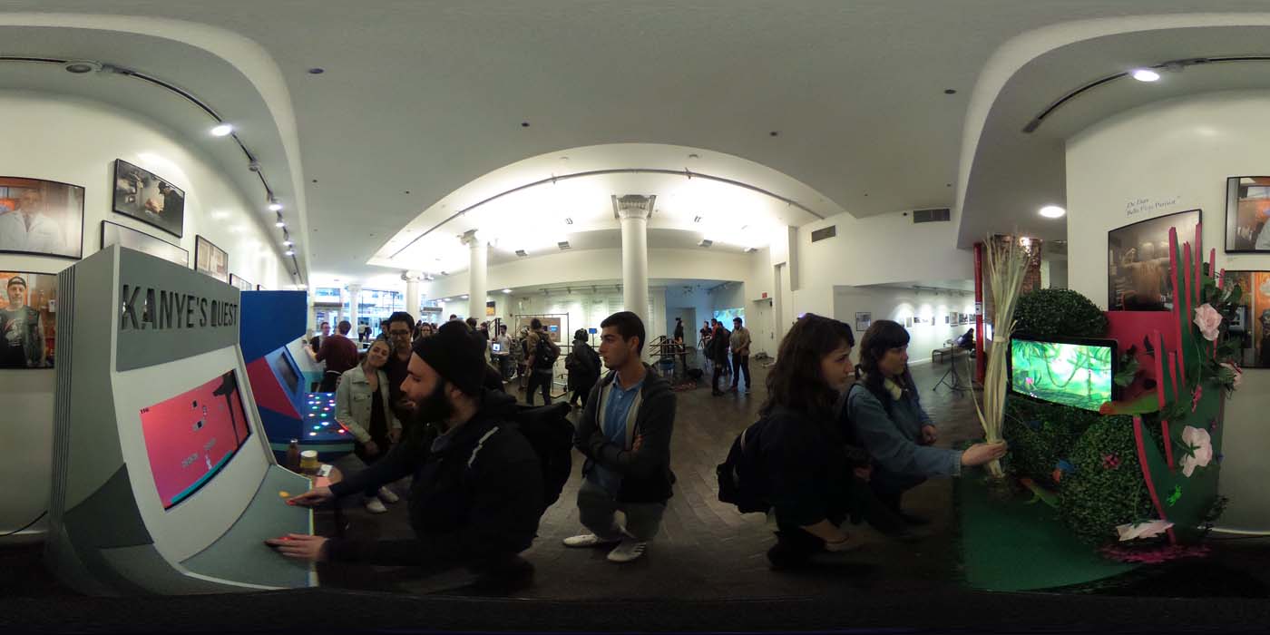 a 360 image of the hallway and people standing by projects at the show